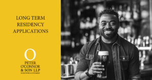 Smiling man holding a pint in an Irish bar, illustrating long-term residency